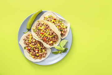 Plate with tasty fresh tacos on color background