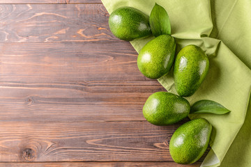 Fresh ripe avocados on wooden background
