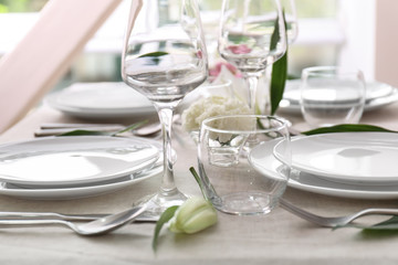 Beautiful festive table setting with flowers