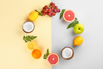 Frame made of different fruits on color background