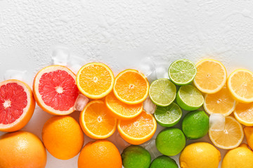 Different cut citrus fruits on white background