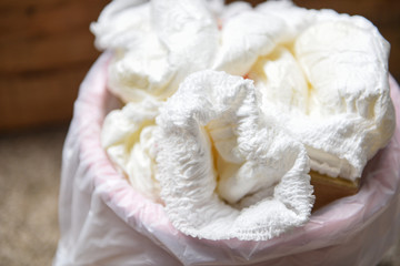 Diapers waste - dirty diapers in a garbage pail Disposing of used baby nappies