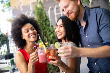 Young friends having a great time together. Group of people talking and smiling.