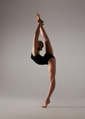 Fototapeta na wymiar Beautifull flexible blonde girl posing. Gymnastics. 