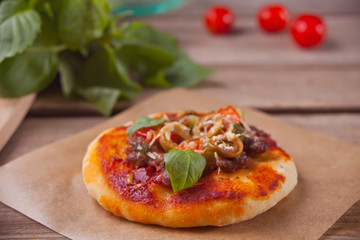 Homemade mini pizza on the black plate