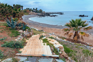 wooden walkway leading to a rocky beach in the vicinity of the Greek city of Rethymnon