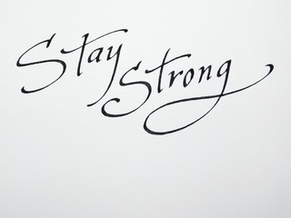 Stay strong -inspiring, motivation quote isoalted on a white background black text. Handwriting inscription, saying. Lettering and calligraphy for postcards and banners, minimalist tattoo