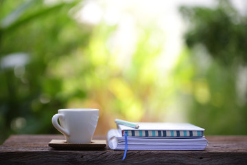 White cup and notebook at outdoor