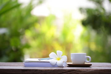 White cup and notebook at outdoor