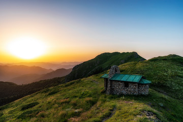 Beautiful clear sky summer sunset in the mountains. Landscape with sun light shining