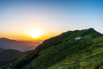 Beautiful clear sky summer sunset in the mountains. Landscape with sun light shining