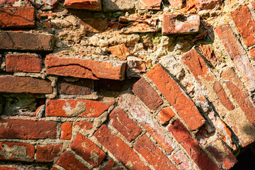 Red brick wall with chipped pieces