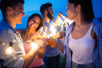 Carefree group of happy friends enjoying party on rooftop terrace