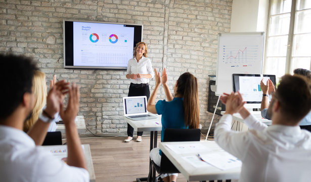 Successful happy group of people learning software engineering and business during presentation