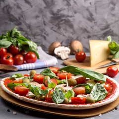 Fast homemade vegetarian pizza with mushrooms on a gray table