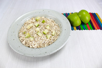 dish with oatmeal and pieces of apple and pear, Nutritious breakfast food healthy oatmeals