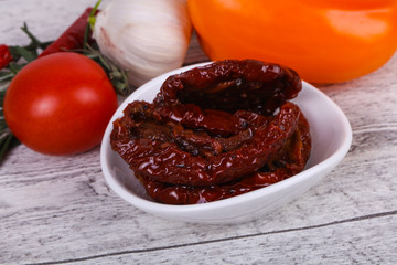 Dried tomatoes in the bowl with olive oil