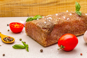 Raw pork loin with vegetables, species and herbs