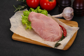 Raw Turkey steak served rosemary