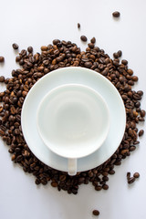 cup of coffee with beans on white background
