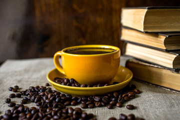 cup of coffee and beans on wooden table