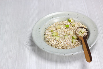 dish with oatmeal and pieces of apple and pear, Nutritious breakfast food healthy oatmeals