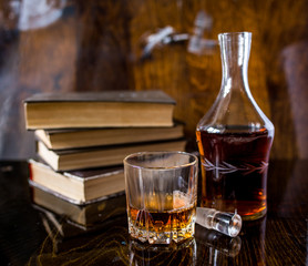 glass of whiskey and ice on wooden table