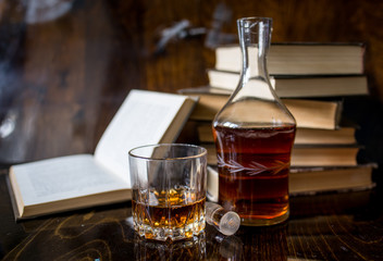 glass of whiskey and ice on wooden table
