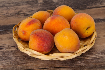 Peach heap in the wooden basket