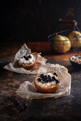 Baked pear with honey, cottage cheese and currants. Fresh homemade dessert. Food composition in a low key. Copy space.