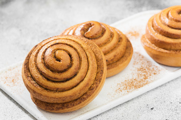 Cinnamon rolls on a light background. Butter baking