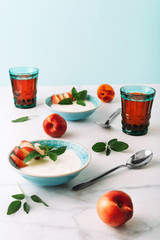 Healthy breakfast of natural greek yoghurt, nectarines and juice on marble table. Close-up.