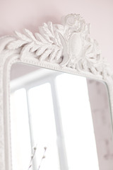 Vintage Baroque mirror with wood carvings in the Royal interior. Close up. Soft focus.