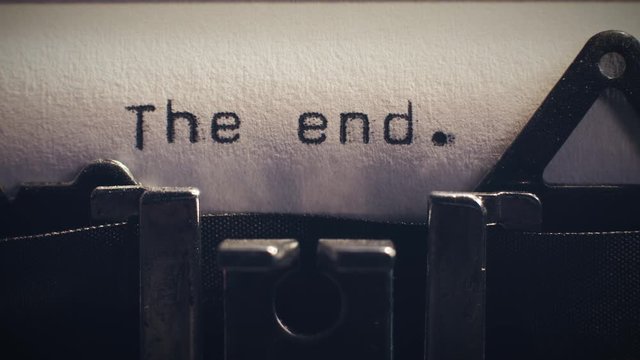 The word 'the end' being typed on a vintage typewriter. Can be used as the end title for a movie.