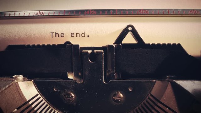Vintage typewriter with the word 'the end' being typed.