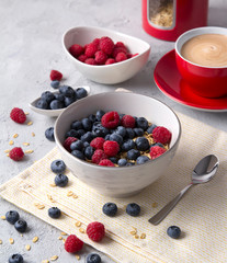 Healthy breakfast with oatmeal, coffee and berries.