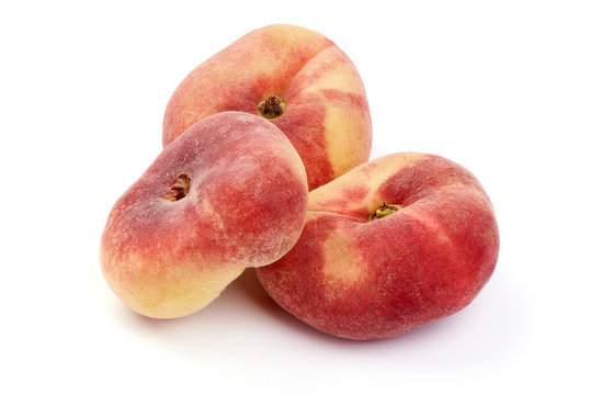 Flat Peaches, ripe nectarines, close-up, isolated on white background
