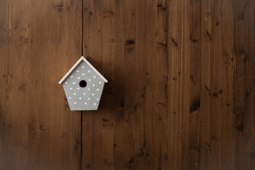 wooden blue bird boxes or birdhouses on a wooden wall, place for text