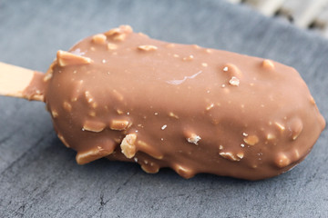 Vanilla milk chocolate almond bar ice cream on black background