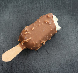 Vanilla milk chocolate almond bar ice cream on black background