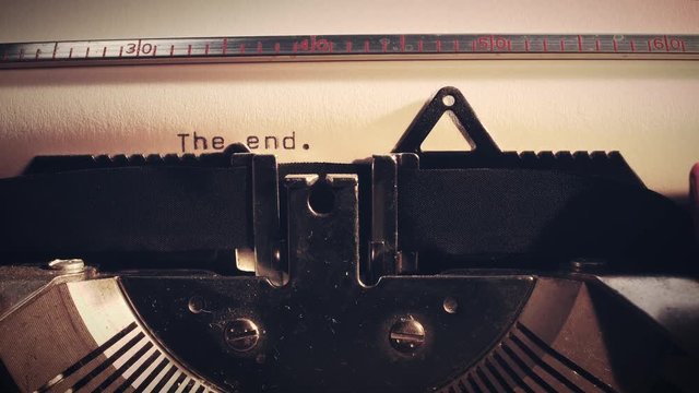 The word The End' being typed on a vintage old typewriter