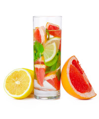 cold drink with different citrus and herbs in glasses on a white background. Cocktail