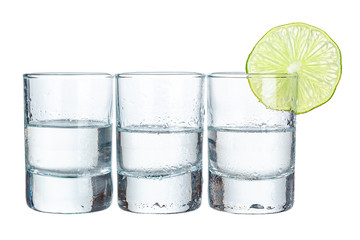 Three  tequila shots with lime isolated on white background - obrazy, fototapety, plakaty