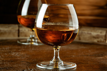 Two glasses of whiskey on a wooden table in the bar
