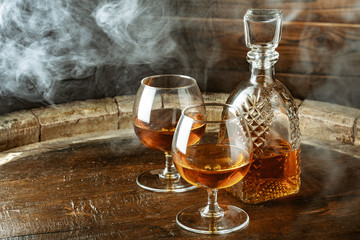 Cognac or whiskey in glasses on rustic backgrpund