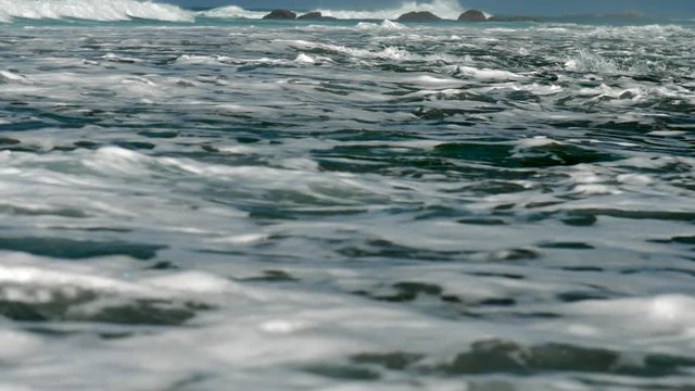 tremendous rugh ocean waves roll on brown rocks and foam on water surface slow motion. Concept tsunami impact and low tide