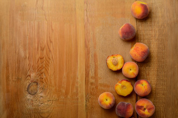 Fresh ripe peaches fruits on wooden rustic background. Top view.
