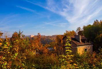 A cozy house is elegantly located among the golden trees
