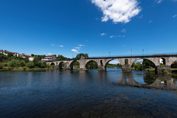 View of the old bridge over the Lima River at the village of Ponte da Barca in the Minho Region of Portugal.