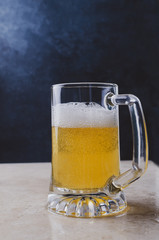 Glass of light beer  on marble table.